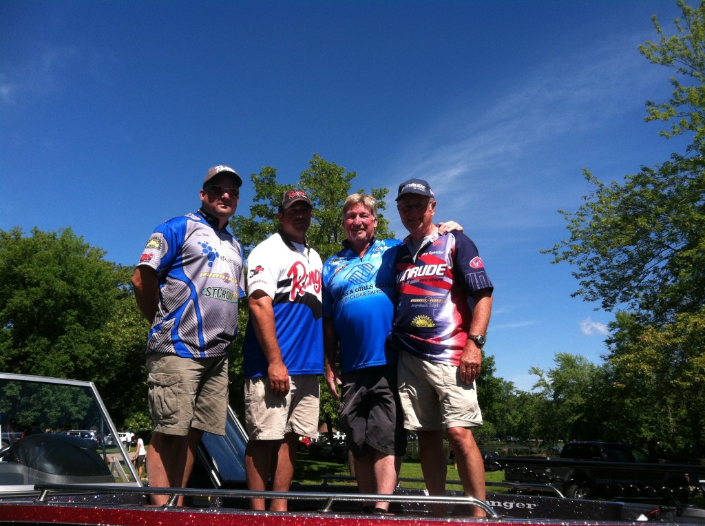Steve, Mike, and Spike with Dave Nichols, event director, on the bow of Mike's Ranger!