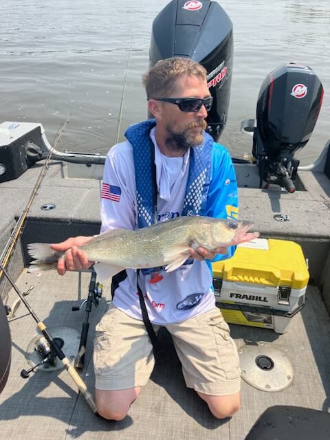 Angler holding a Pool 10 fish during the 2025 tournament (gallery view)