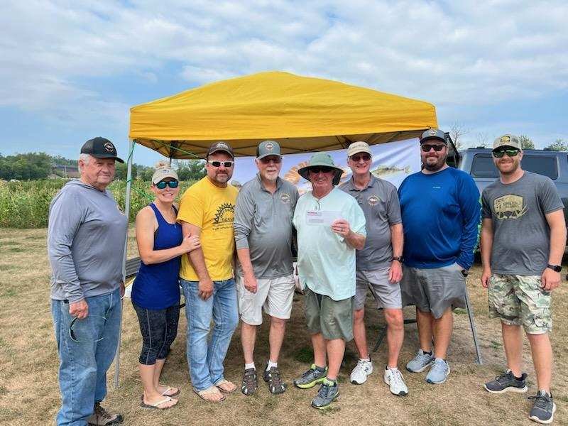 Fish-O-Rama scene with anglers and volunteers