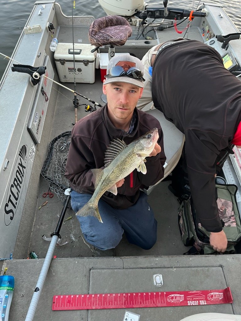 Angler Mike holding a Coralville Reservoir walleye at the boat