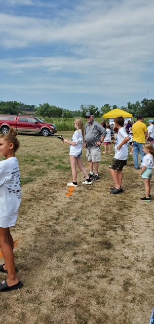 Volunteer helping a young angler at Fish-O-Rama (gallery view)