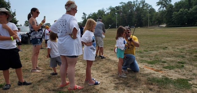Participants fishing and smiling at Fish-O-Rama (gallery view)