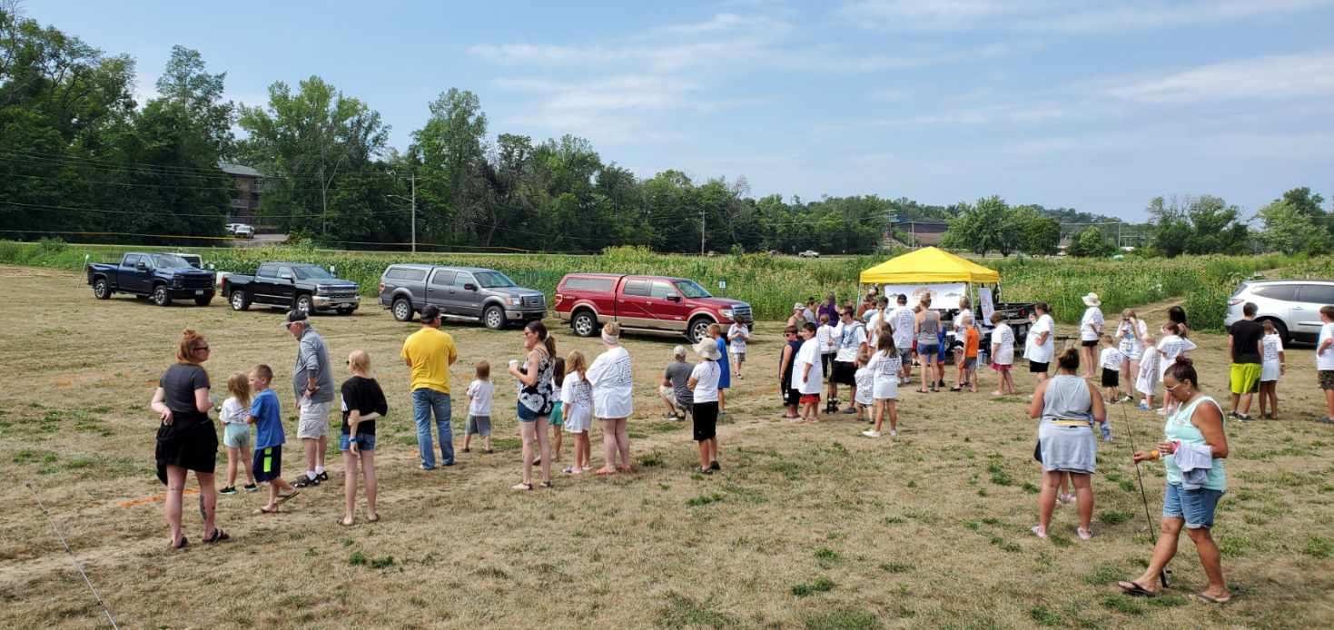 Fish-O-Rama dock scene with anglers and volunteers